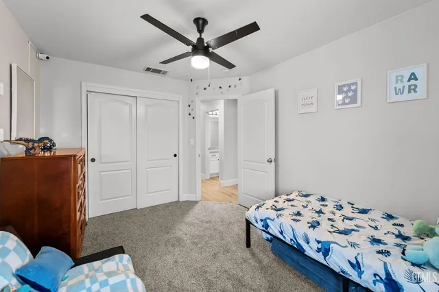 a bedroom with a bed and a dresser