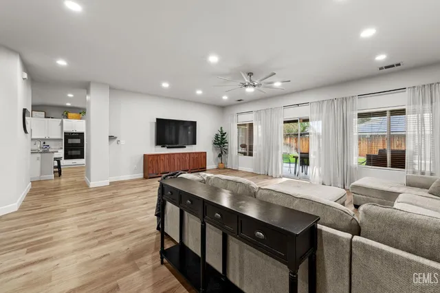 a living room with stainless steel appliances kitchen island granite countertop furniture and a kitchen view