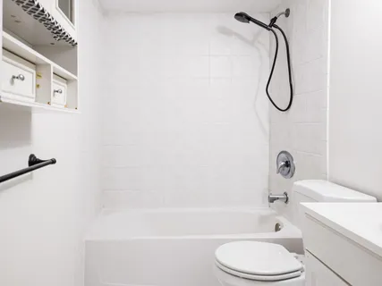 a bathroom with a sink a toilet and a bath tub
