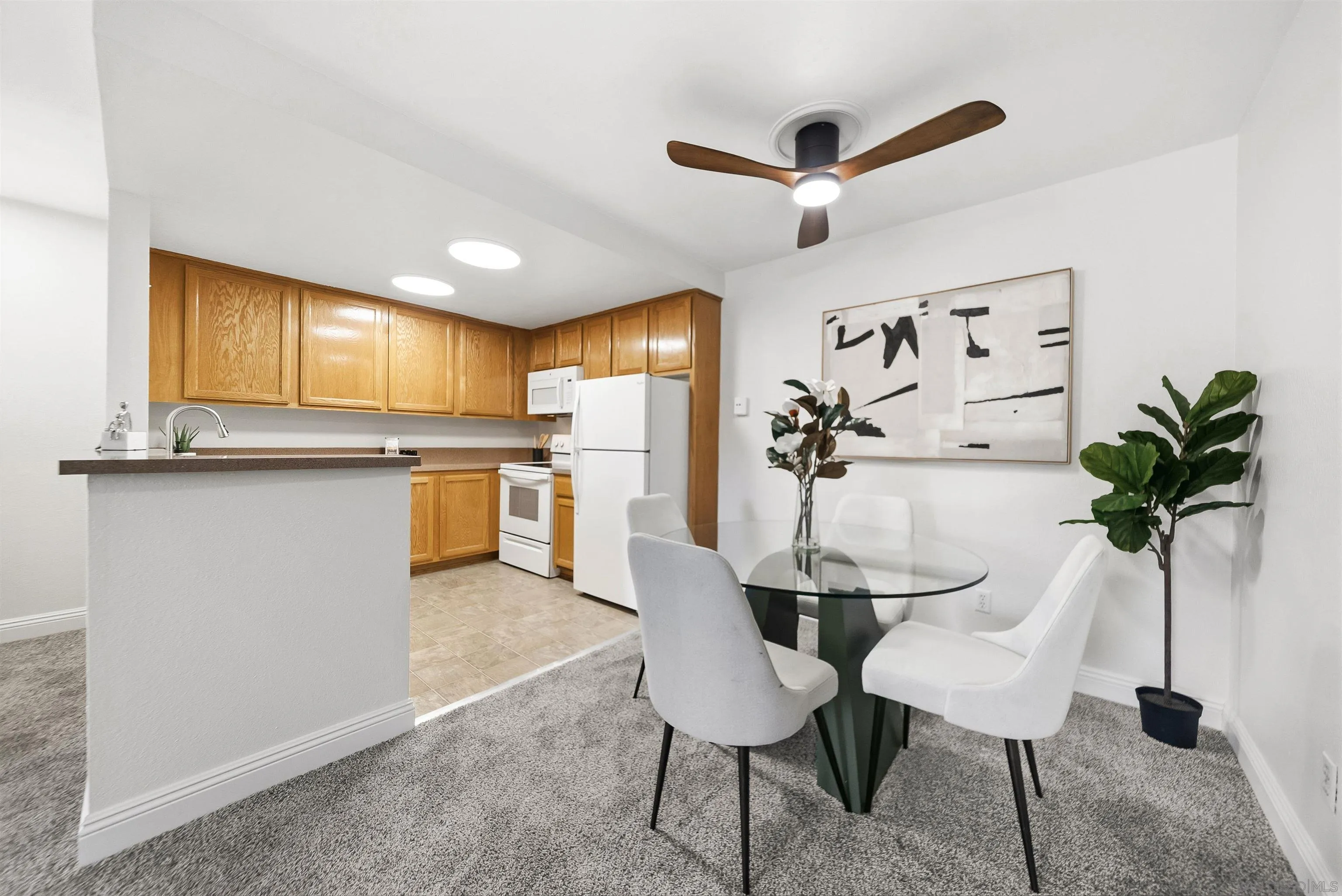 5922 Rancho Mission Road, Unit 74 San Diego, CA 92108 - Photo 11 of 43 a view of a kitchen with a table and chairs in it