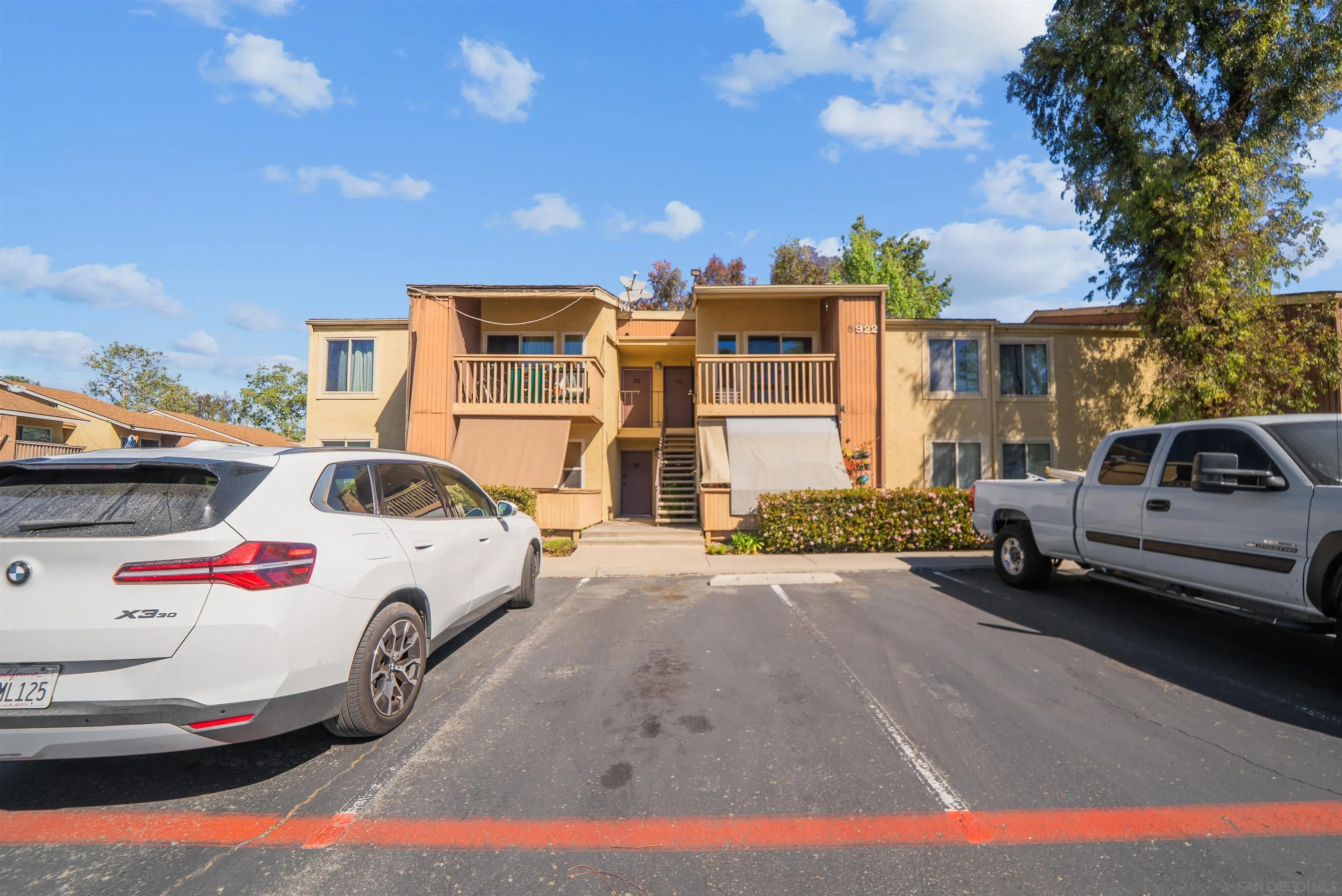 5922 Rancho Mission Road, Unit 74 San Diego, CA 92108 - Photo 42 of 43 a car parked in front of a house