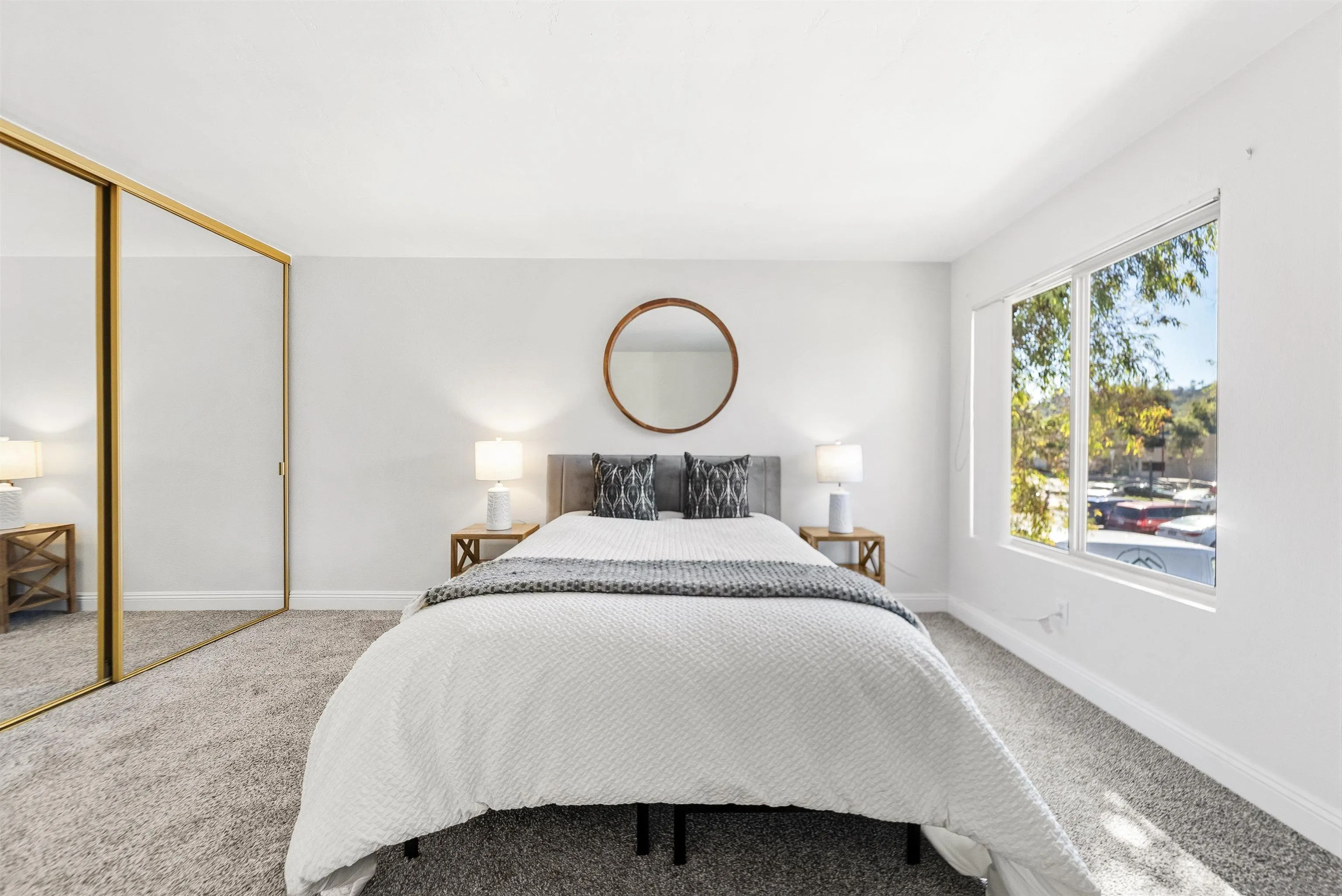 5922 Rancho Mission Road, Unit 74 San Diego, CA 92108 - Photo 7 of 43 a bedroom with a bed and a window