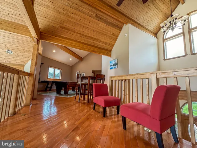 a living room with furniture a fireplace and wooden floor
