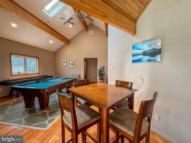 a dining room with a wooden table and chairs