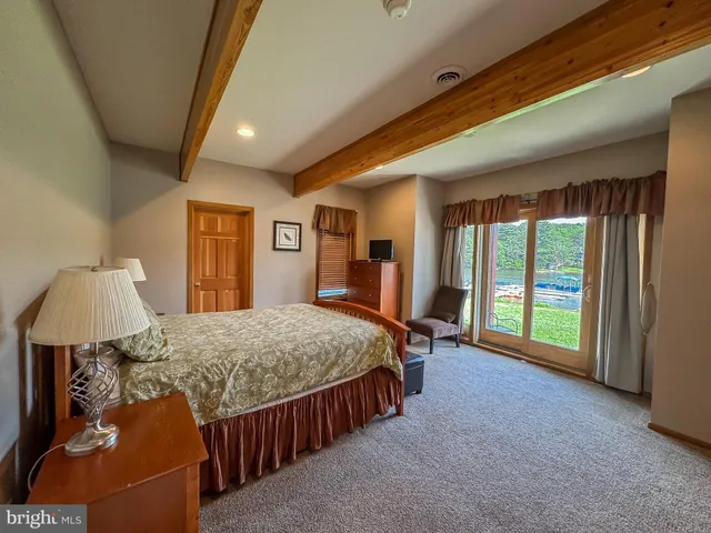 a bedroom with a bed and a mirror