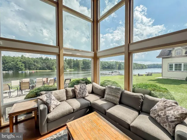 a living room with a couch and a floor to ceiling window