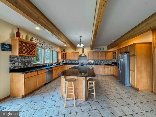a kitchen with stainless steel appliances granite countertop a sink and cabinets