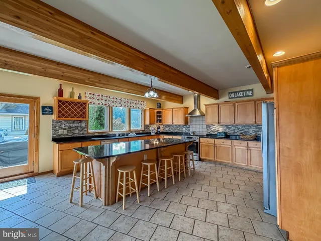 a large kitchen with a table and chairs