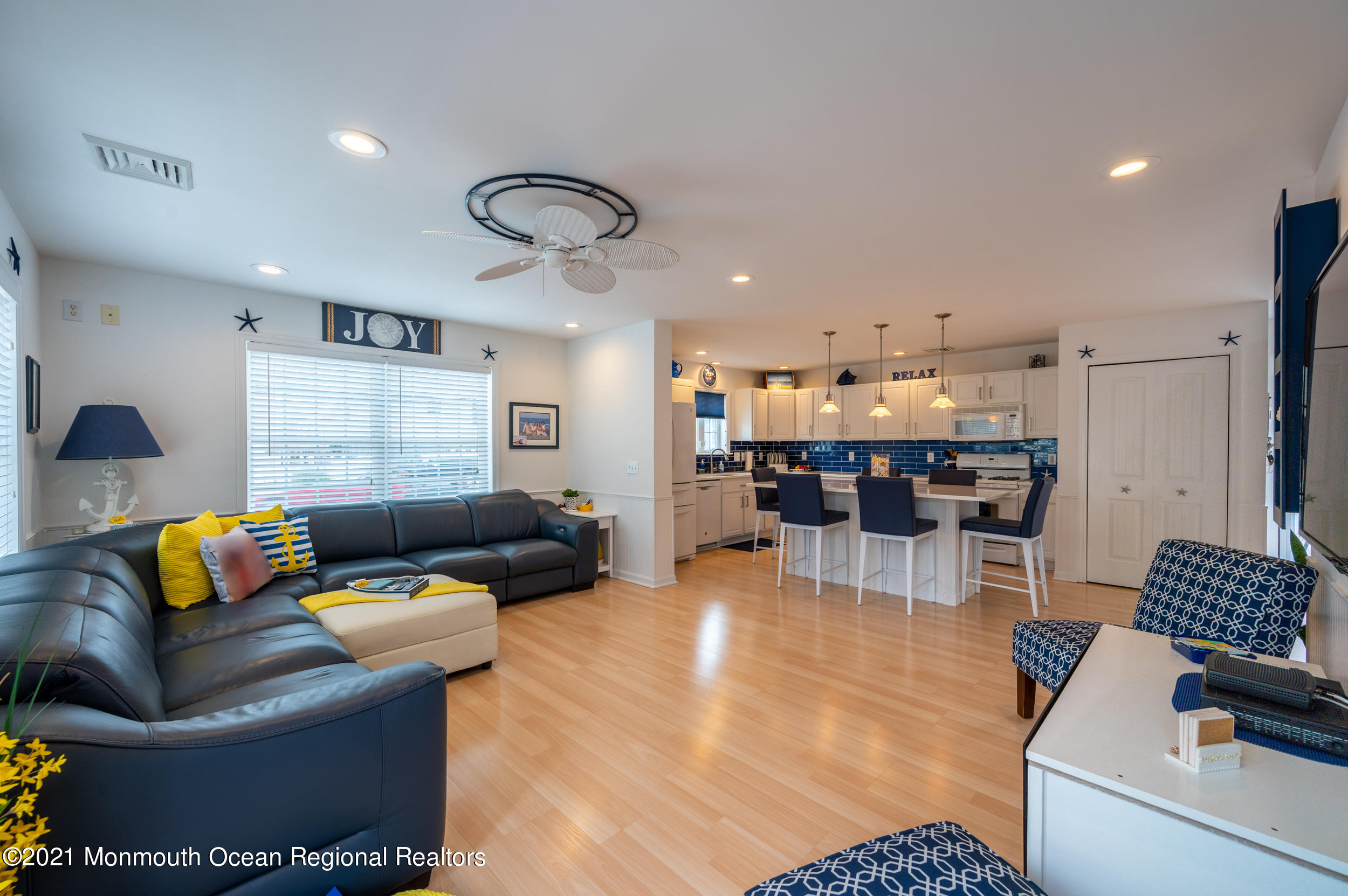 a living room with furniture and kitchen view