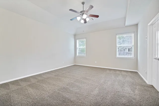 a view of an empty room with chandelier