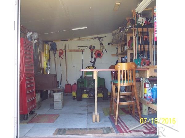 740 North Hemlock Road Hemlock, MI 48626 - Photo 15 of 15 attached to the garage is this workshop area or storage area for lawnmower and yard tools.