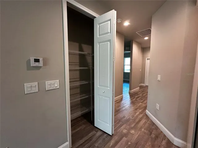 a large kitchen with stainless steel appliances granite countertop a large counter top a sink and a stove