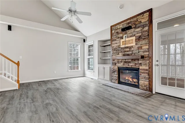 a kitchen with stainless steel appliances granite countertop a sink a stove and a wooden floors