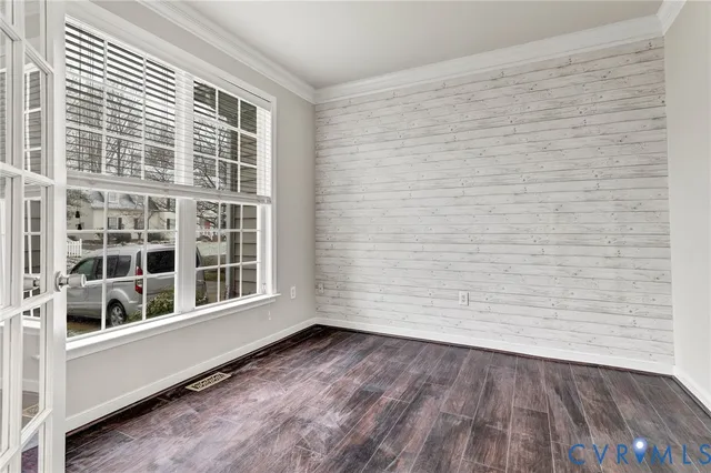 a view of an empty room with a fireplace and a window