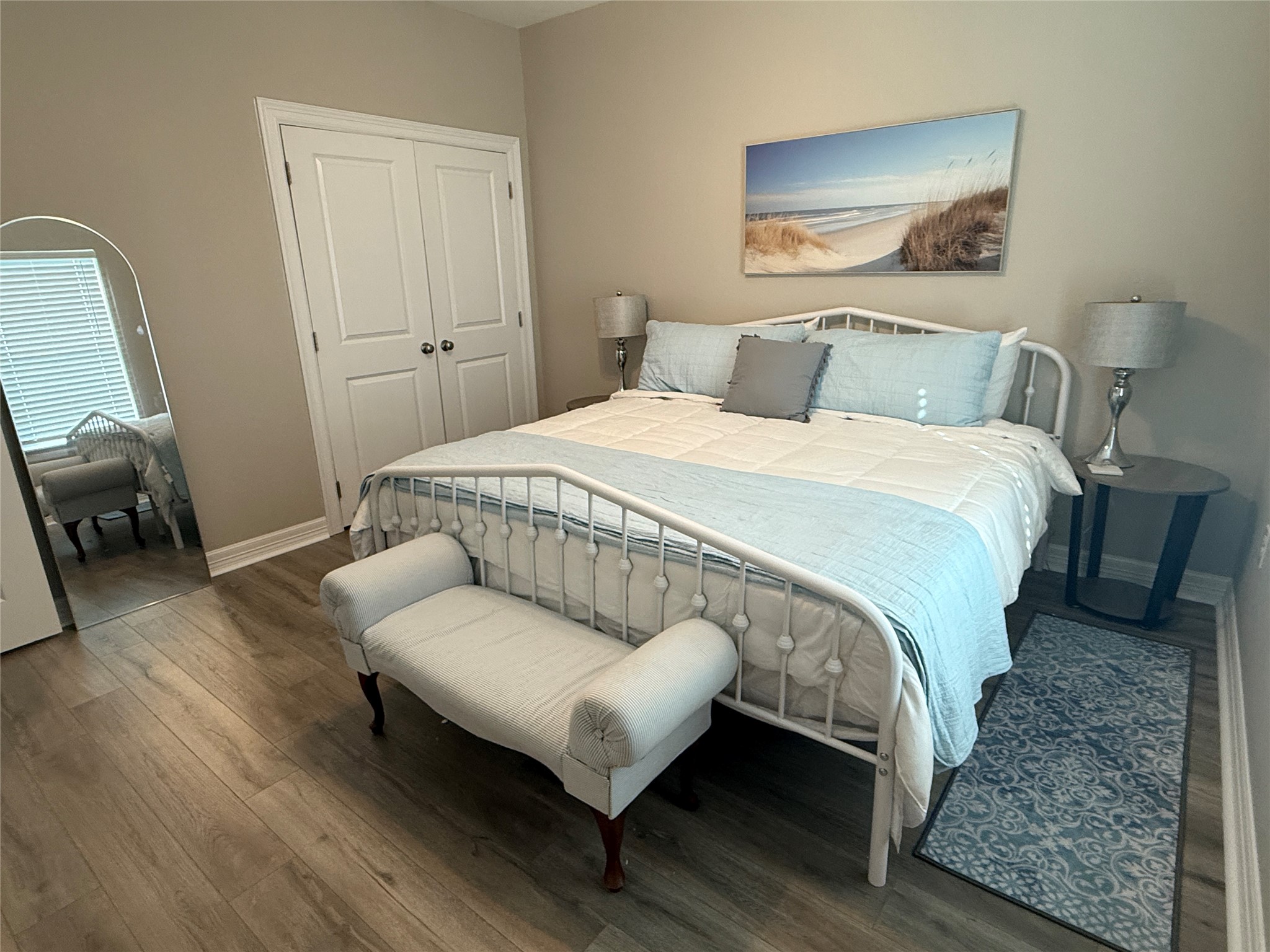 528 Thunder Road Surfside Beach, TX 77541 - Photo 20 of 22 a bedroom with a bed and wooden floor