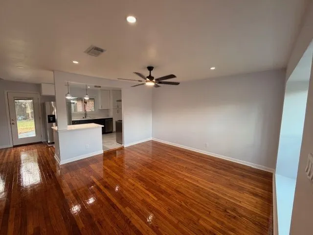 a view of a kitchen with a sink and a refrigerator