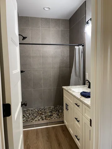 a bathroom with a shower and a sink