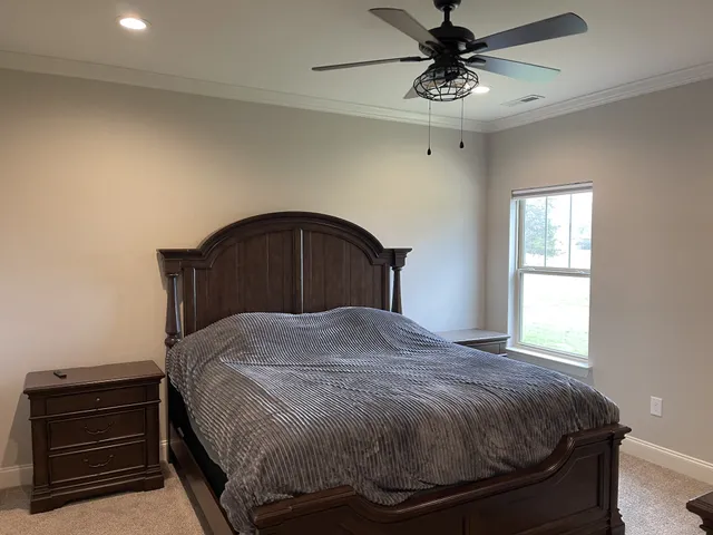 a bedroom with a bed and a chandelier