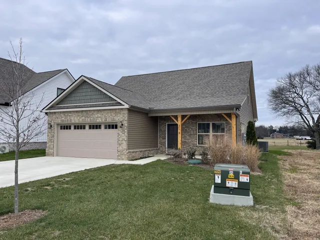 a front view of a house with garden