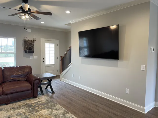 a living room with furniture and a flat screen tv