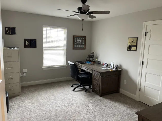 a room with a window and a desk