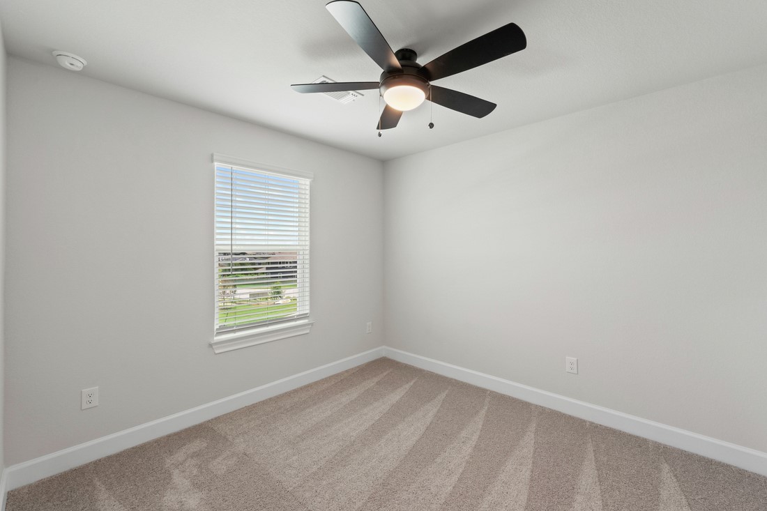 9517 Balmy Lane Manor, TX 78653 - Photo 11 of 17 an empty room with a window and a fan