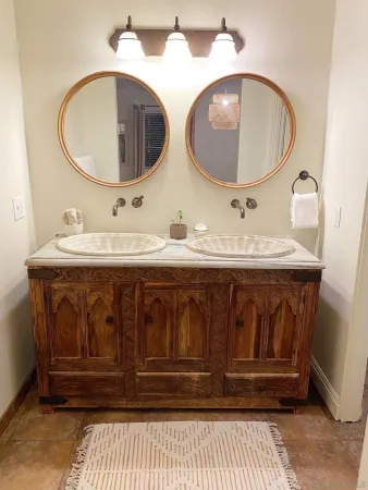 a bathroom with 2 sink and a mirror