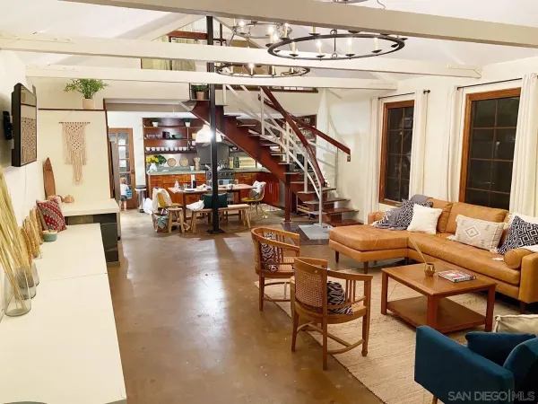a view of a livingroom with furniture and a window