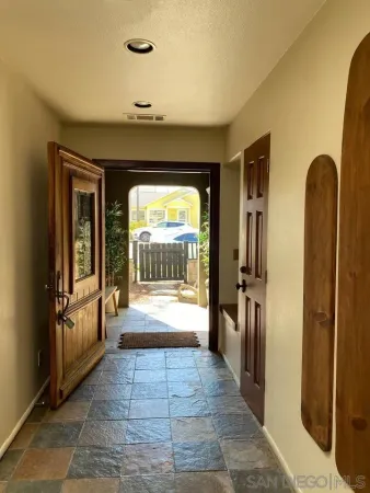 a view of a hallway view with wooden floor and staircase