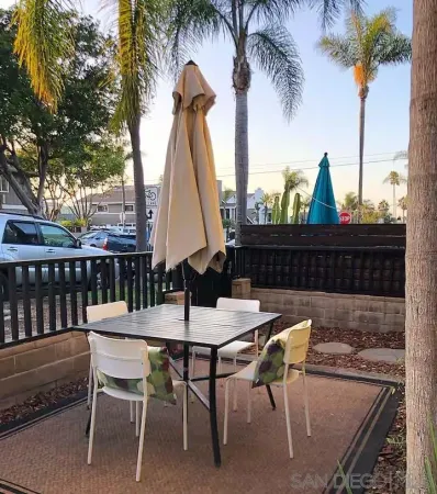 a view of a dinning table and chairs in patio