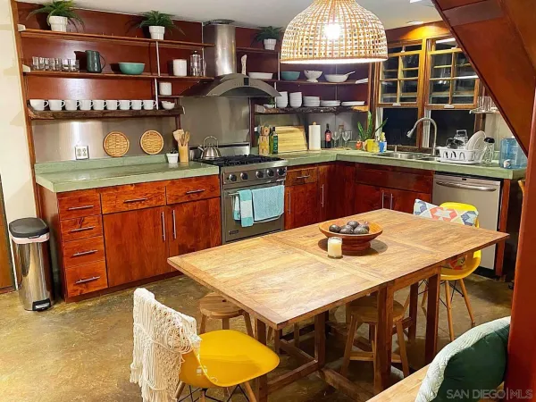 a kitchen with stainless steel appliances granite countertop a stove a sink and a white cabinets