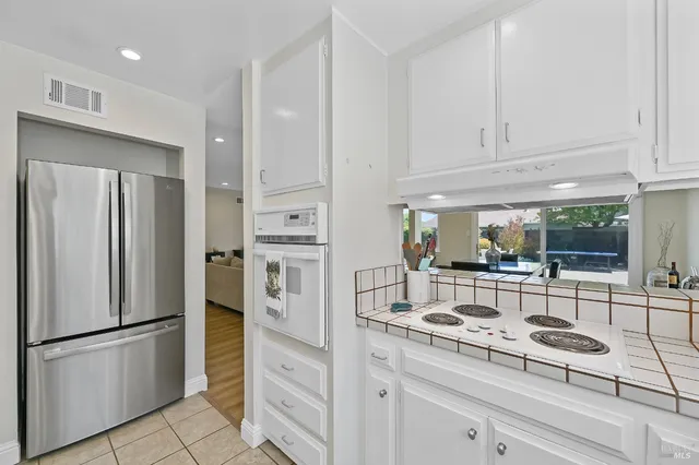a kitchen with stainless steel appliances a refrigerator sink and cabinets