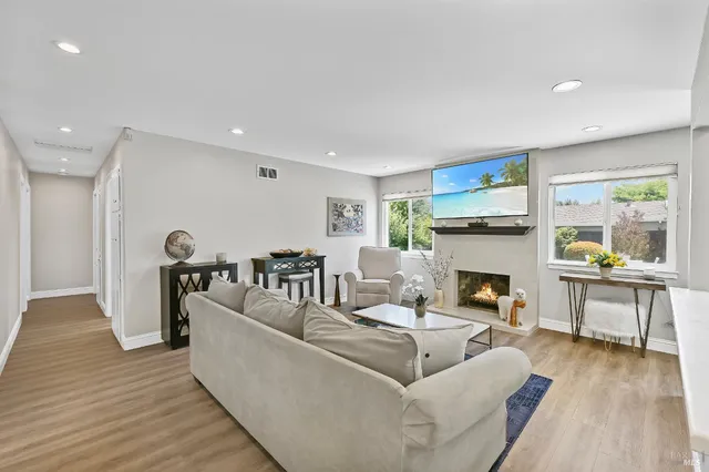 a living room with furniture and a fireplace
