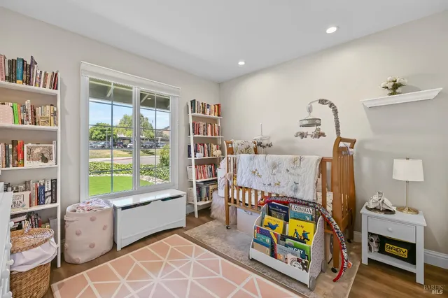 a bedroom with furniture and a wooden floor