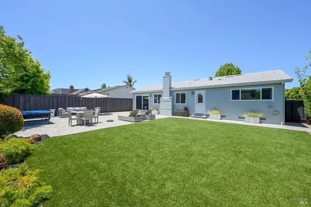 a front view of house with yard and outdoor seating