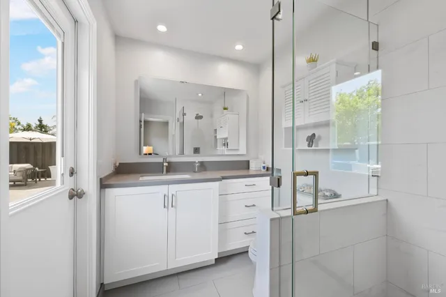 a bathroom with a sink a vanity and a mirror