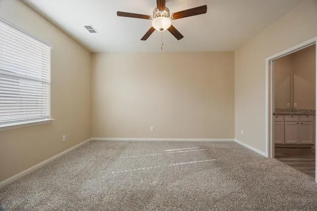 a view of a livingroom with a ceiling fan and window
