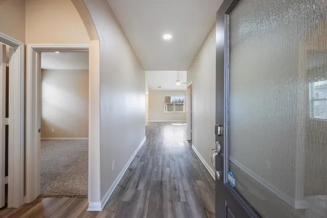 a view of hallway with wooden floor