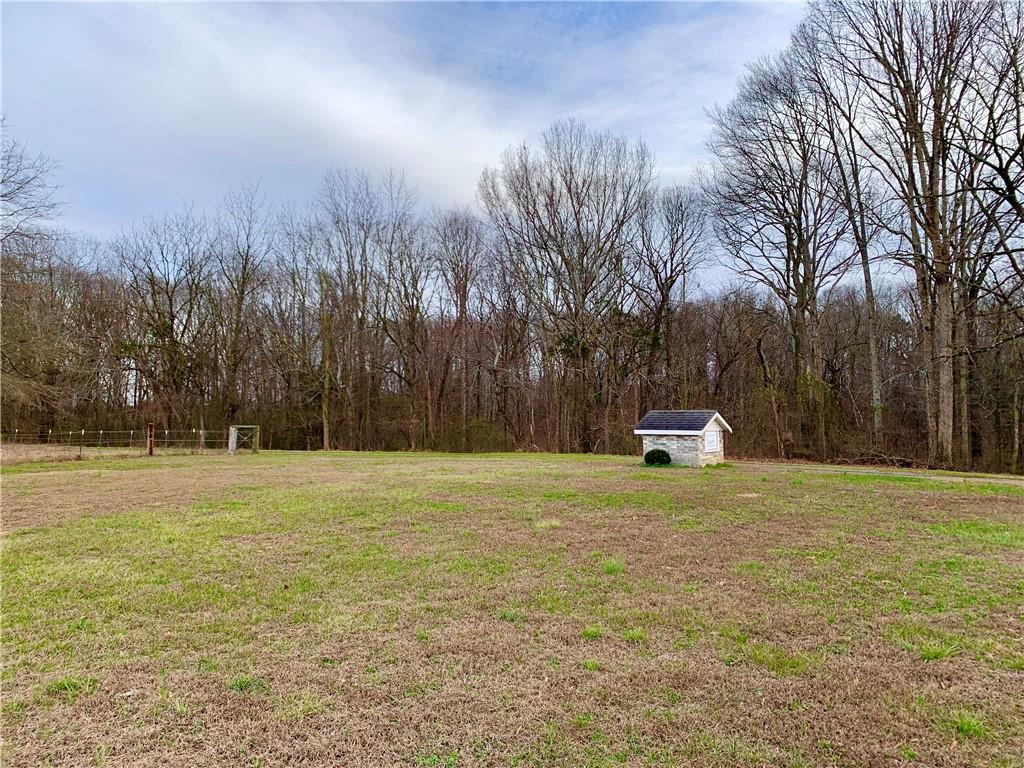 6911 Alexander Farm Road Monroe, NC 28110 - Photo 15 of 48 a view of a field with trees in the background