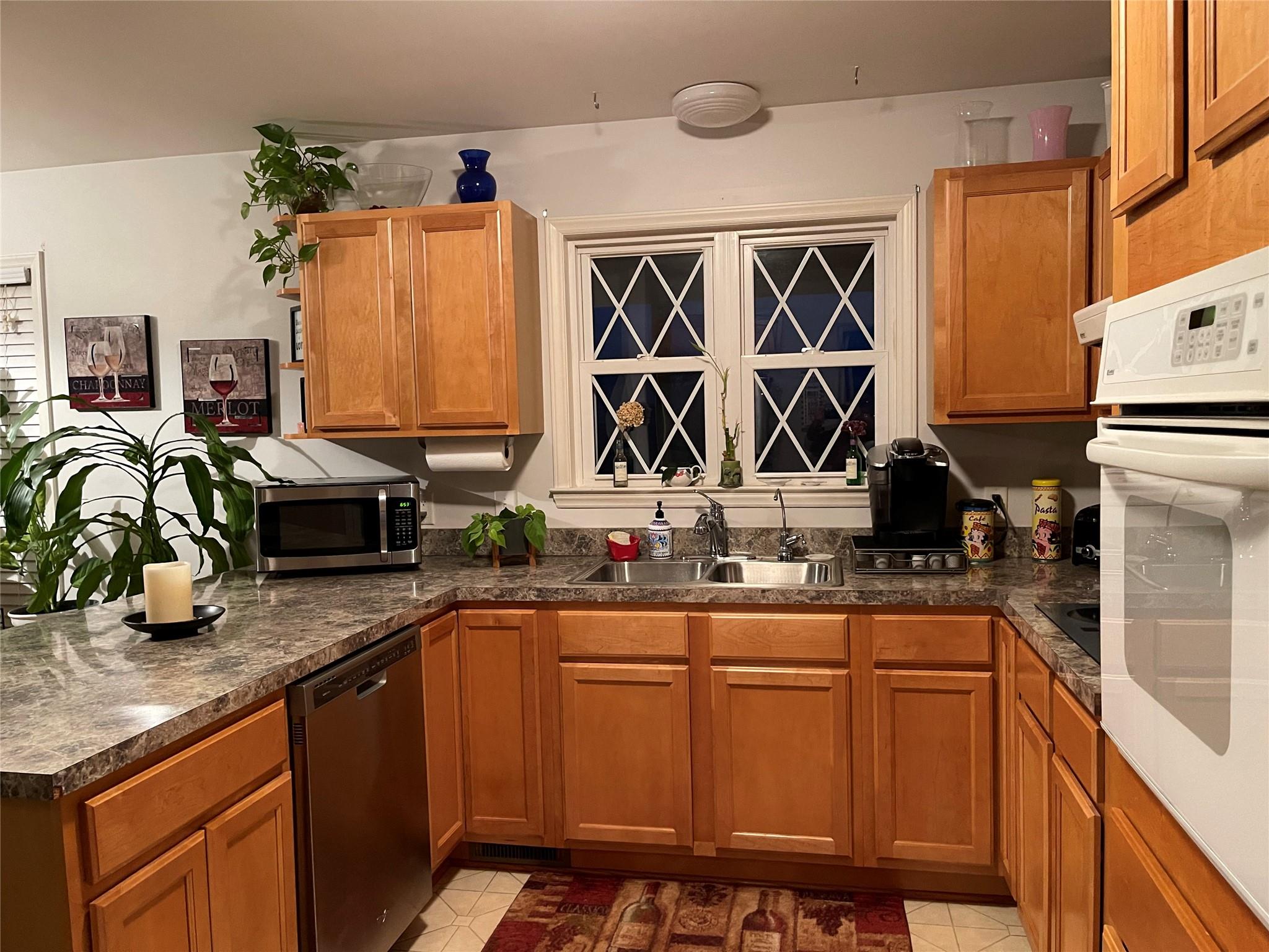 6911 Alexander Farm Road Monroe, NC 28110 - Photo 18 of 48 a kitchen with stainless steel appliances granite countertop a sink a stove and a wooden cabinets