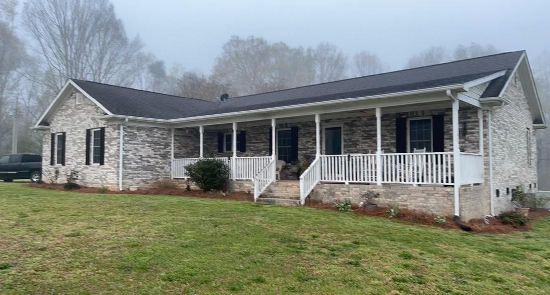 6911 Alexander Farm Road Monroe, NC 28110 - Photo 3 of 48 a view of a house with a yard and porch with a garden