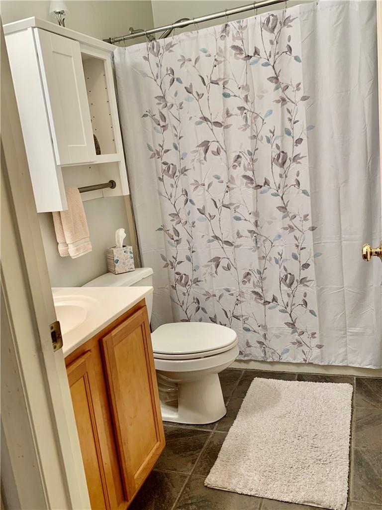 6911 Alexander Farm Road Monroe, NC 28110 - Photo 31 of 48 a bathroom with a toilet and a shower curtain