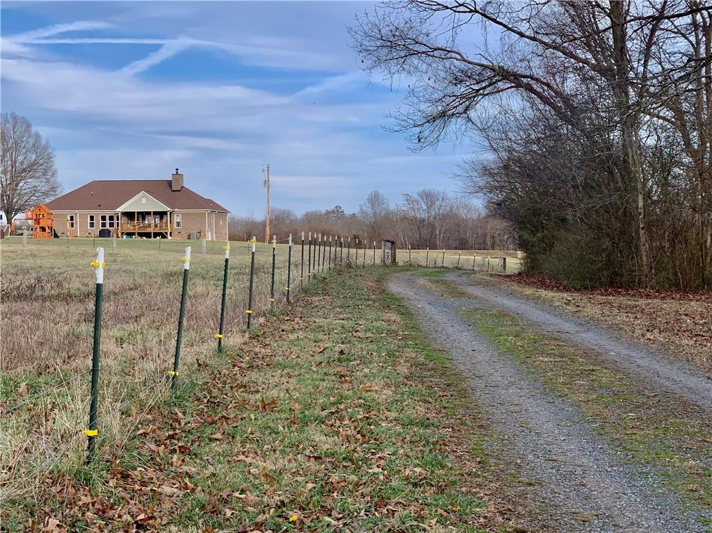 6911 Alexander Farm Road Monroe, NC 28110 - Photo 10 of 48 a view of a yard in front of a house with a yard