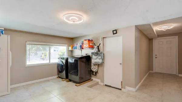 a living room with furniture kitchen view and a window