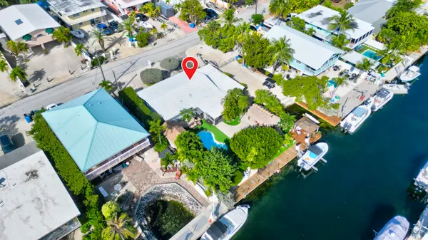 a kitchen with stainless steel appliances kitchen island granite countertop a refrigerator and a sink