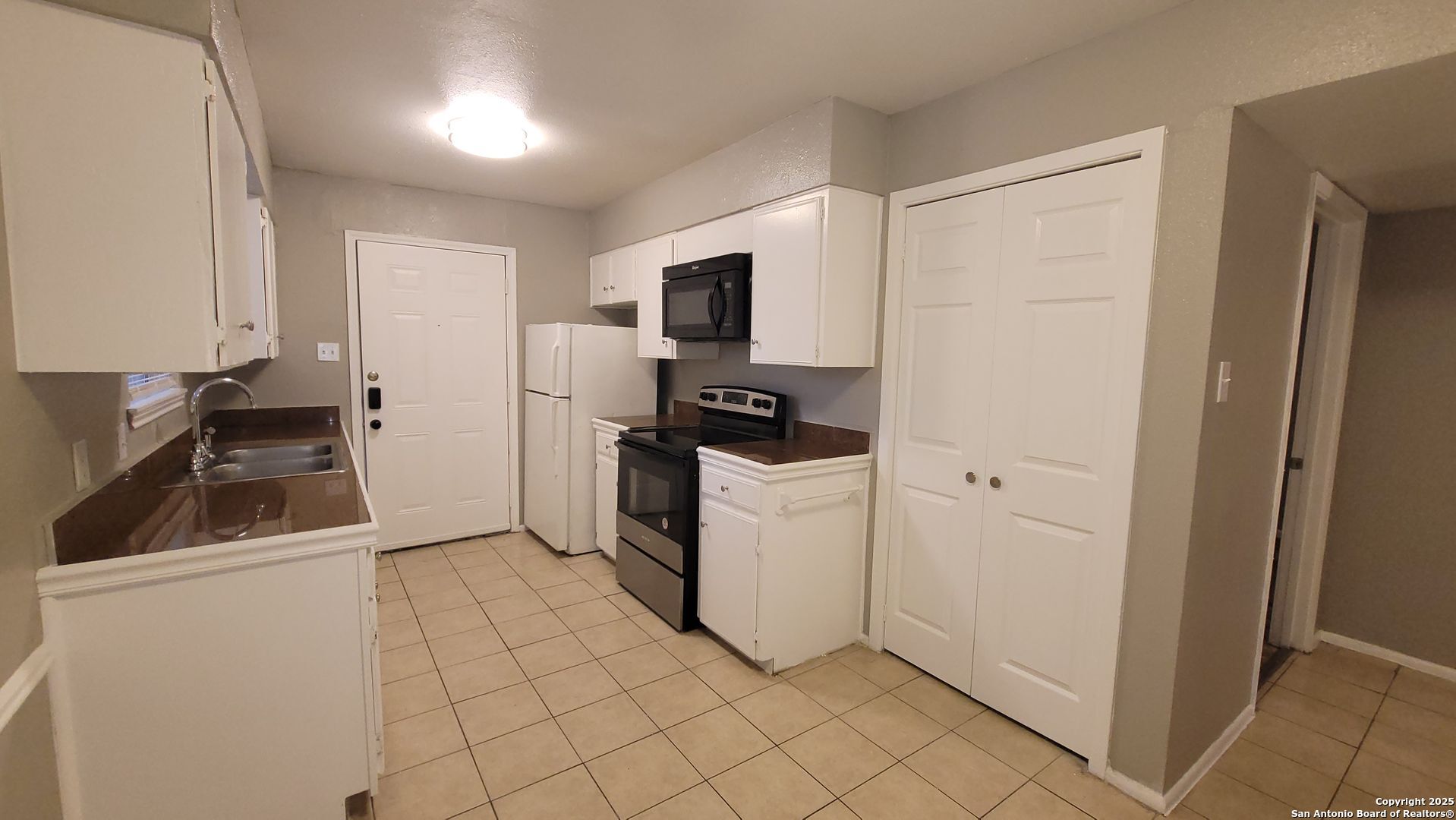 516 Gentleman Road, Unit 5 Balcones Heights, TX 78201 - Photo 4 of 15 a kitchen with a refrigerator and white cabinets