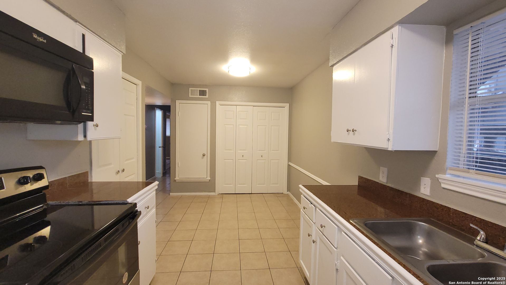 516 Gentleman Road, Unit 5 Balcones Heights, TX 78201 - Photo 6 of 15 a kitchen with granite countertop a sink stainless steel appliances and cabinets