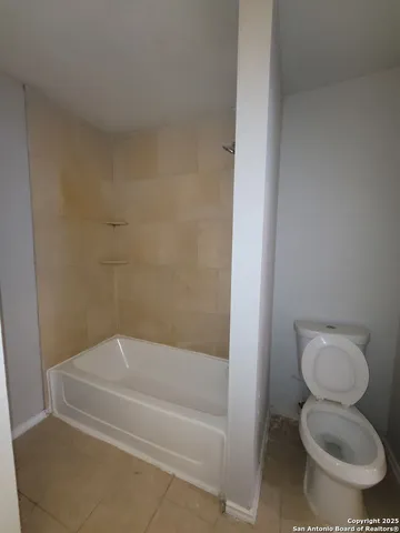 a bathroom with a toilet and a bathtub