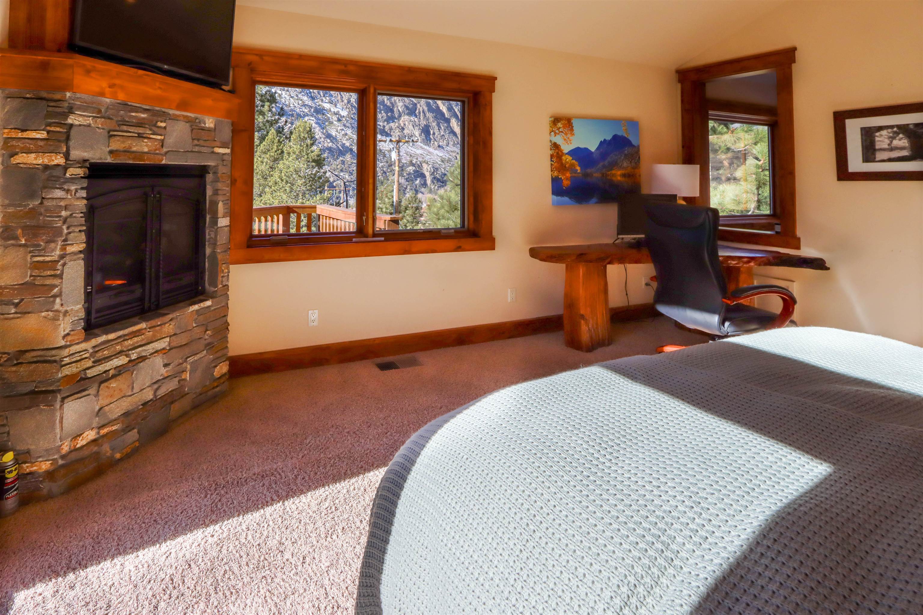 131 West Steelhead Road June Lake, CA 93529 - Photo 16 of 47 a bedroom with furniture and a fireplace