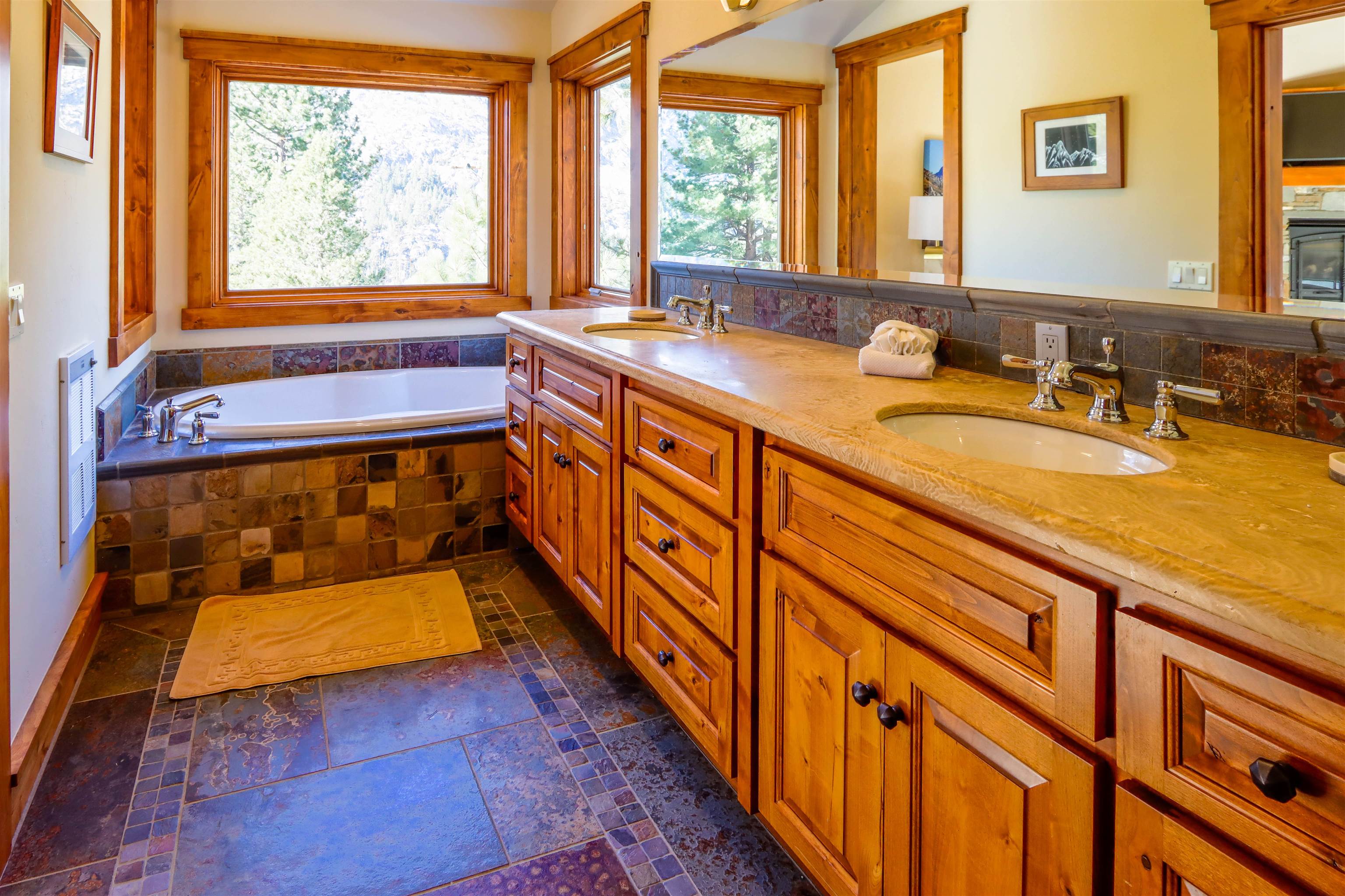 131 West Steelhead Road June Lake, CA 93529 - Photo 20 of 47 a bathroom with a granite countertop sink and a large mirror